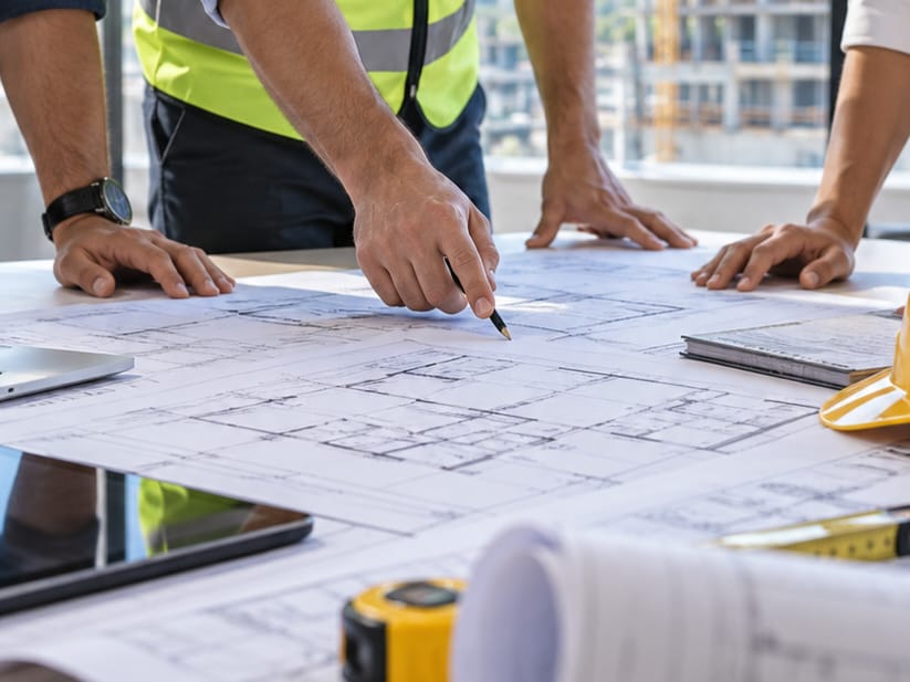 Novex Construction team reviewing building plans on site